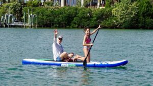 Teenage girl paddleboarding on calm water near Siesta Key