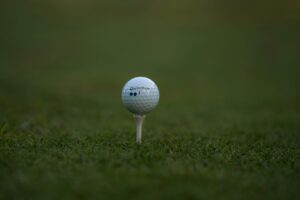 Close-up of a golf ball on a tee ready for a swing, representing golf getaways near Siesta Key, Florida.