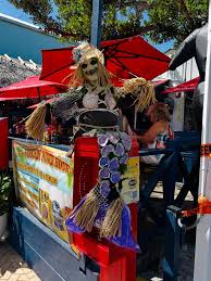 A Halloween-themed scarecrow decorated as a mermaid on display at an outdoor restaurant in Siesta Key.