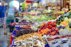 Colorful display of fresh produce, including fruits and vegetables, at a local farmers market.
