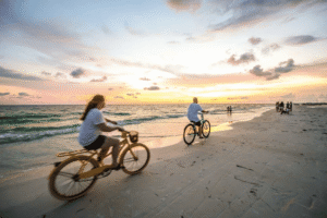 Biking on the beach at sunset on Siesta Key, Florida, a unique coastal cycling experience