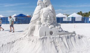 Sand sculpture of Jimmy Buffett with guitar at the Siesta Key Crystal Classic sand sculpting festival.
