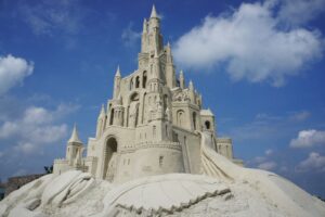 Intricate sandcastle sculpture with towers and arches at Siesta Key Crystal Classic on Crescent Beach.