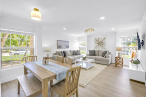 Bright and airy 2-bedroom vacation rental in Siesta Key Village with modern living room, dining area, and natural light throughout
