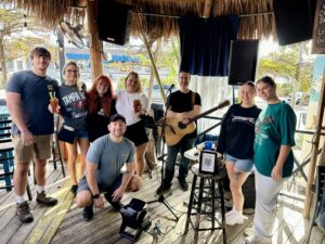 Live acoustic music performance at Siesta Key Oyster Bar (SKOB) in Siesta Key, Florida, with guests enjoying drinks and entertainment in the popular island venue.