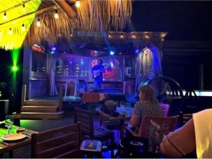 Live acoustic music performance at Sneaky Tiki in Siesta Key, Florida, creating a relaxed island atmosphere for guests enjoying cocktails, dining, and nightlife.