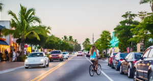 Evening scene in Siesta Key Village with visitors walking past restaurants, shops, and outdoor dining.