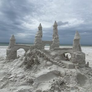 Sandcastle on the white sand of Siesta Key Beach under cloudy skies